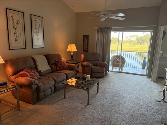 a bedroom with a bed and a lamp on the dresser