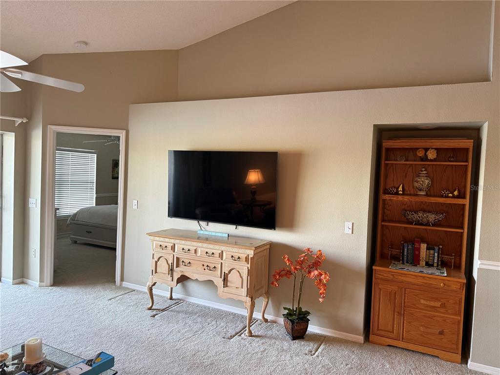 5251 Mahogany Run Avenue, Unit 524 Sarasota, FL 34241 - Photo 19 of 40 a living room with furniture and a flat screen tv