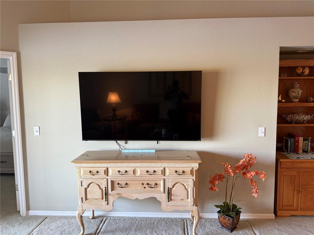 5251 Mahogany Run Avenue, Unit 524 Sarasota, FL 34241 - Photo 20 of 40 a living room with furniture and a flat screen tv