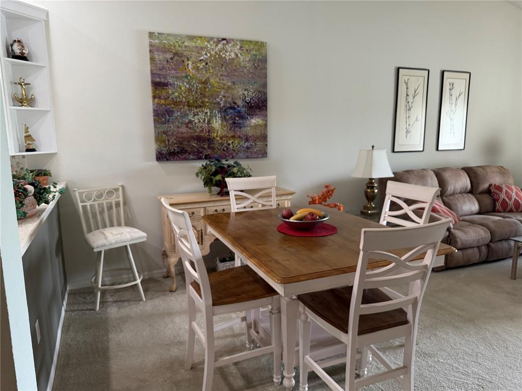 5251 Mahogany Run Avenue, Unit 524 Sarasota, FL 34241 - Photo 21 of 40 a view of a dining room with furniture and wooden floor