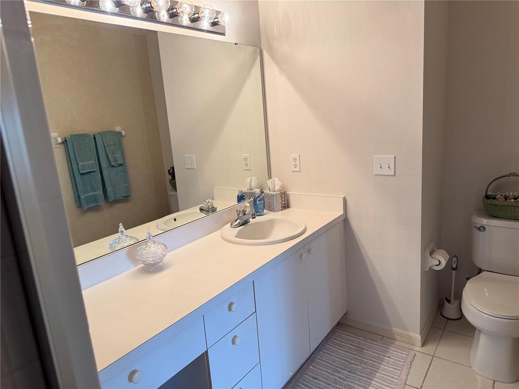 5251 Mahogany Run Avenue, Unit 524 Sarasota, FL 34241 - Photo 24 of 40 a bathroom with a sink and mirror with toilet