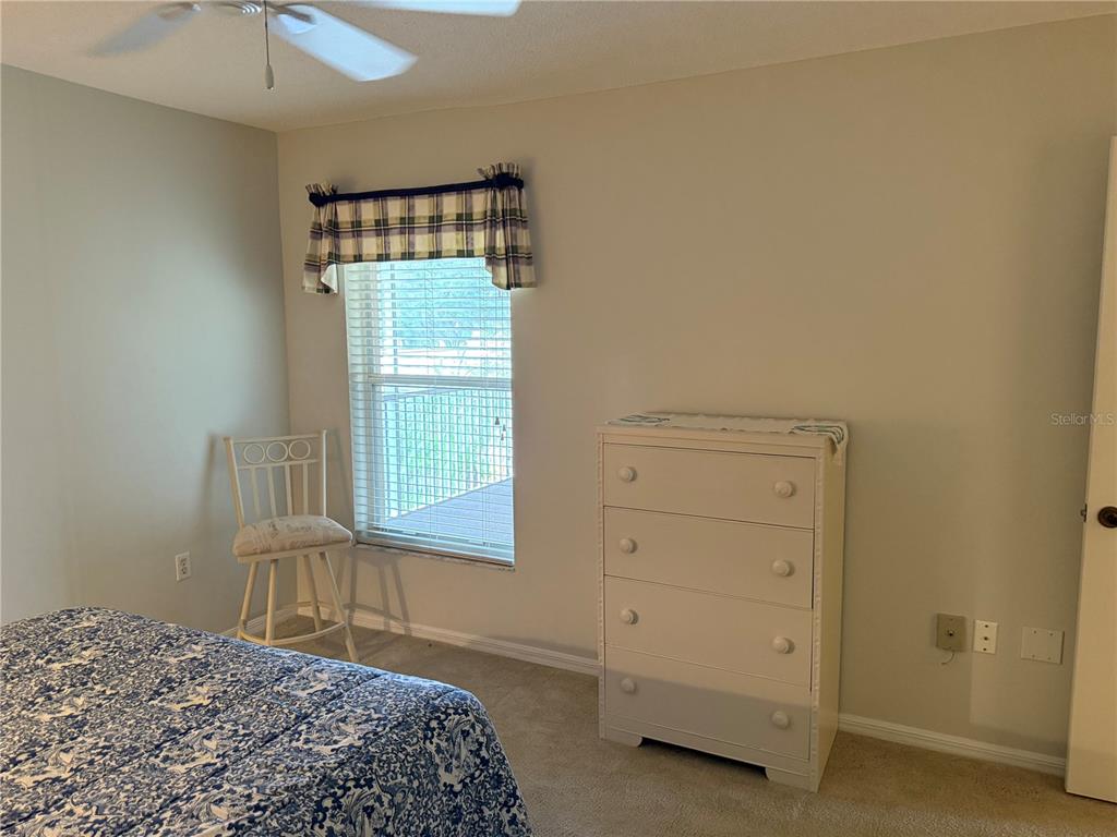 5251 Mahogany Run Avenue, Unit 524 Sarasota, FL 34241 - Photo 27 of 40 a bedroom with a bed and a window