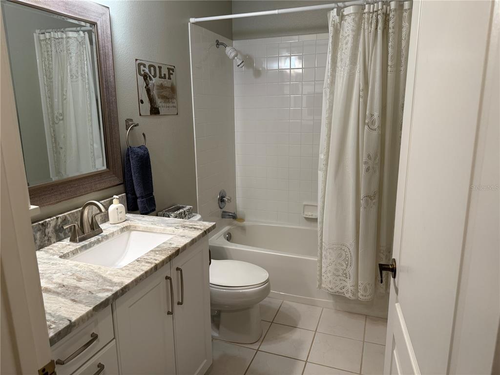 5251 Mahogany Run Avenue, Unit 524 Sarasota, FL 34241 - Photo 29 of 40 a bathroom with a granite countertop sink toilet and shower