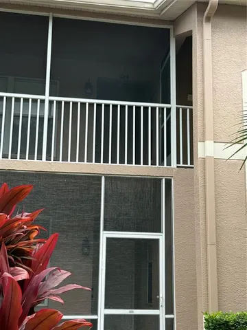 a living room with furniture wooden floor and a large window