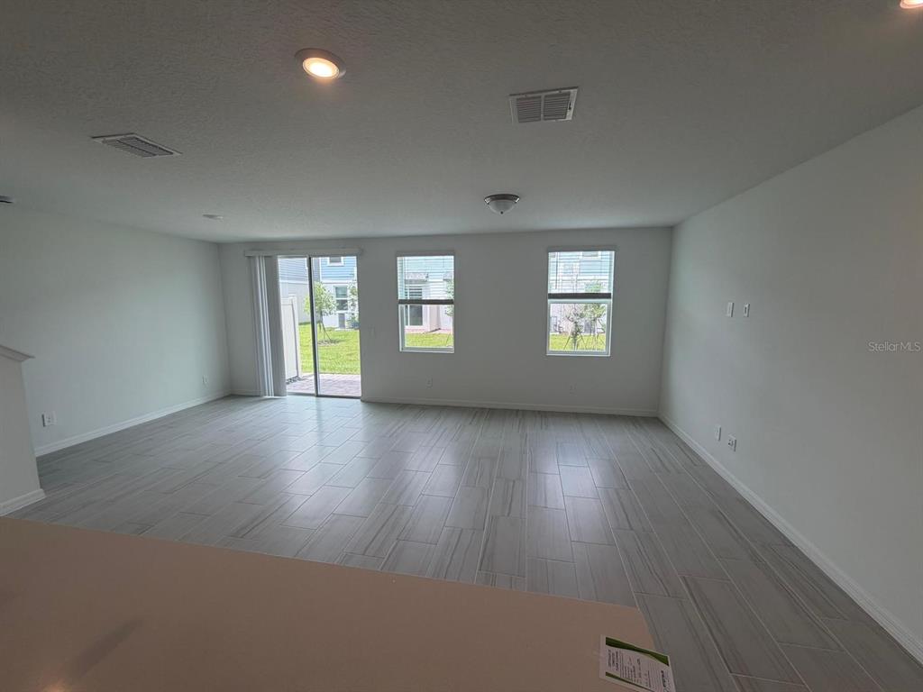 4256 Ranch House Road St. Cloud, FL 34772 - Photo 7 of 30 an empty room with wooden floor and windows
