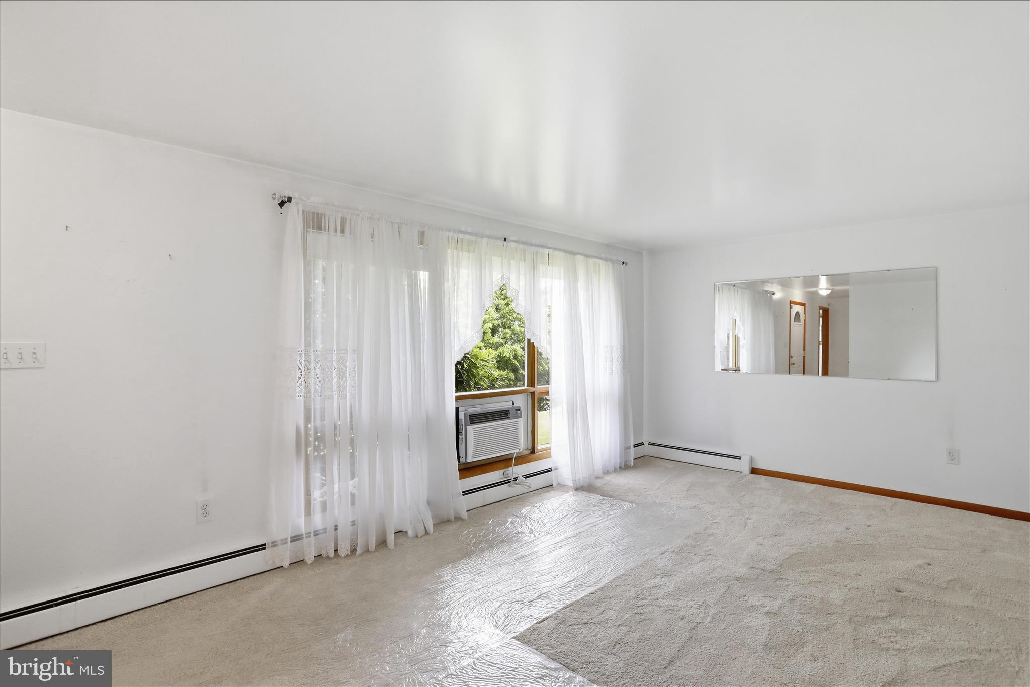 199 Buser Street Ridgeley, WV 26753 - Photo 6 of 49 an empty room with windows and natural light