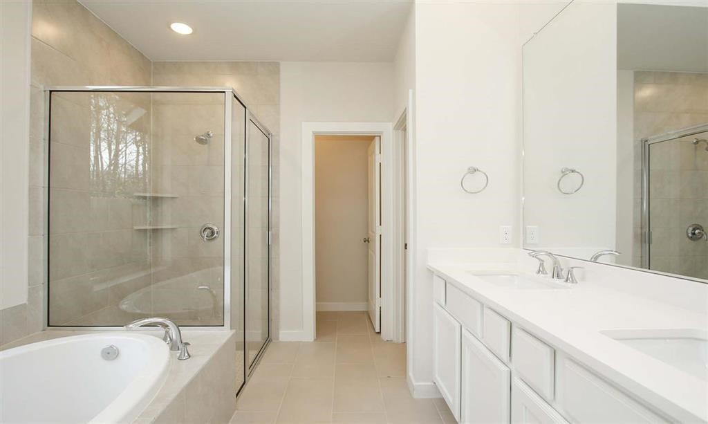 21582 Jordan Pond Ridge Porter, TX 77365 - Photo 13 of 21 a bathroom with a bathtub shower sink and mirror