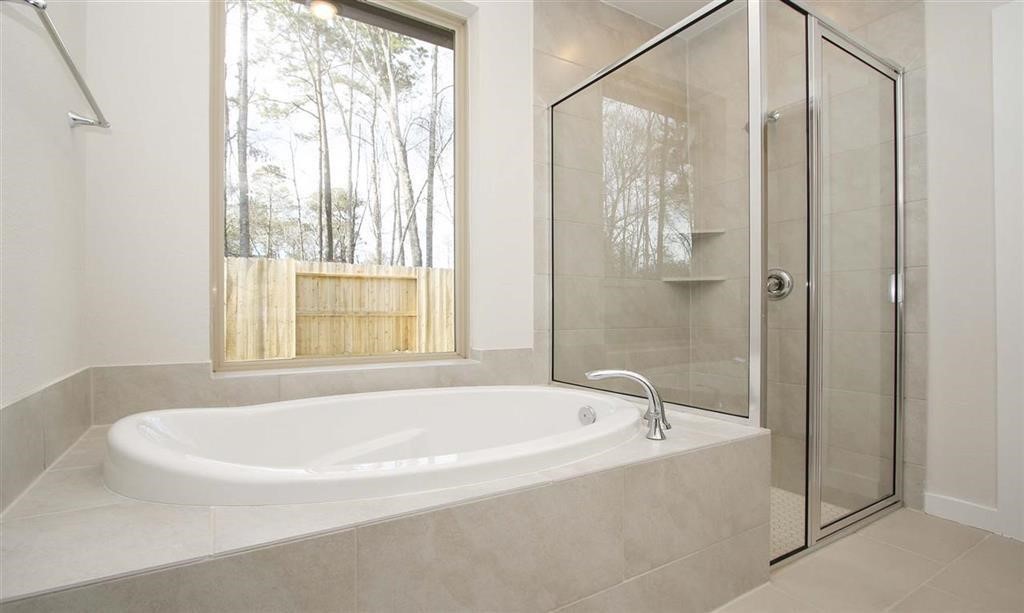 21582 Jordan Pond Ridge Porter, TX 77365 - Photo 15 of 21 a white bath tub sitting next to a shower