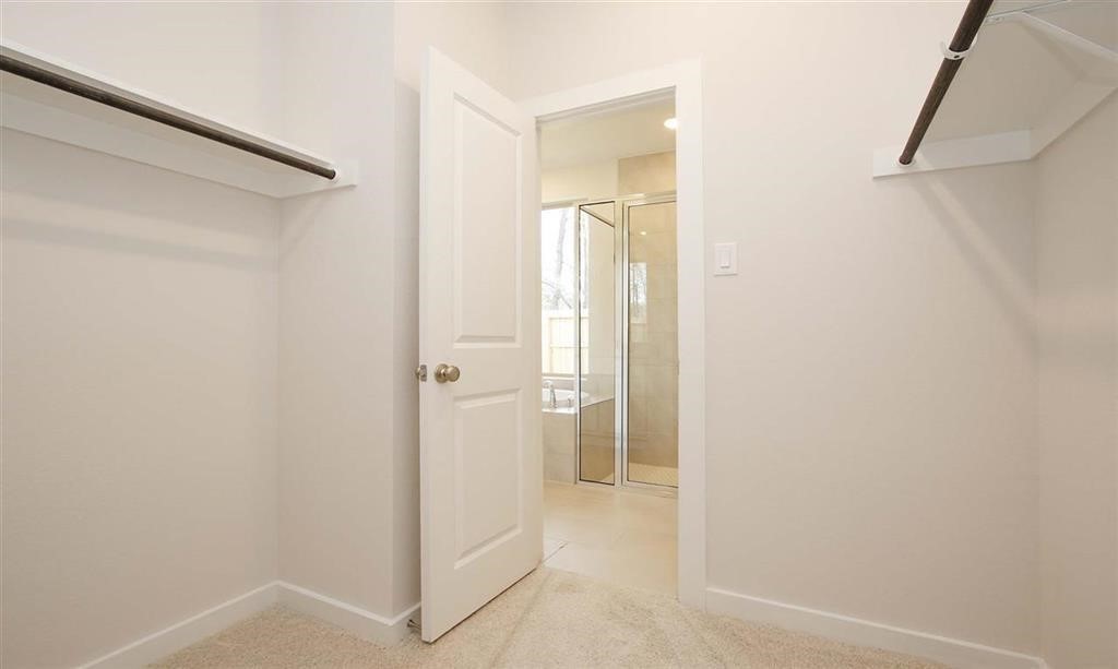 21582 Jordan Pond Ridge Porter, TX 77365 - Photo 18 of 21 a view of a bathroom with a shower and a sink