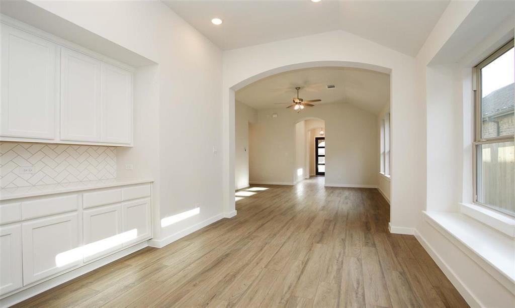 21582 Jordan Pond Ridge Porter, TX 77365 - Photo 20 of 21 a view of a room with wooden floor and window