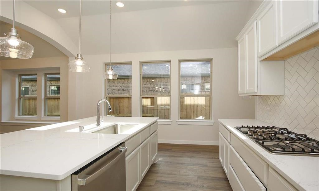 21582 Jordan Pond Ridge Porter, TX 77365 - Photo 4 of 21 a large white kitchen with a large window