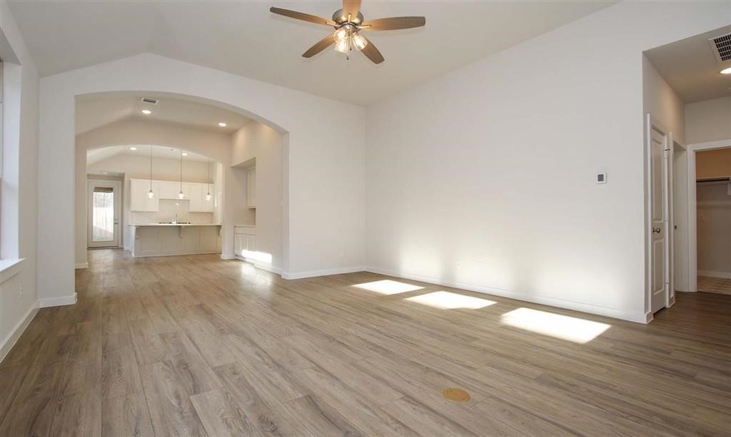 21582 Jordan Pond Ridge Porter, TX 77365 - Photo 7 of 21 wooden floor in an empty room with a window