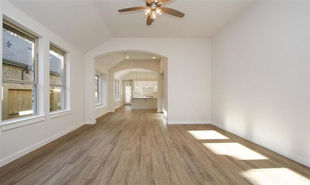 21582 Jordan Pond Ridge Porter, TX 77365 - Photo 8 of 21 wooden floor in an empty room with a window
