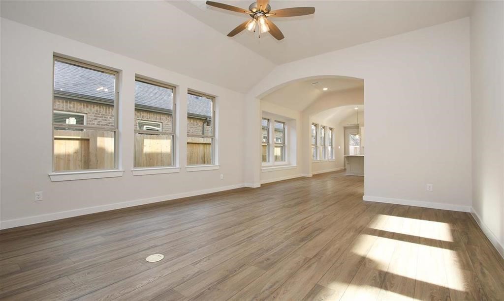 21582 Jordan Pond Ridge Porter, TX 77365 - Photo 10 of 21 a view of an empty room with a window and wooden floor