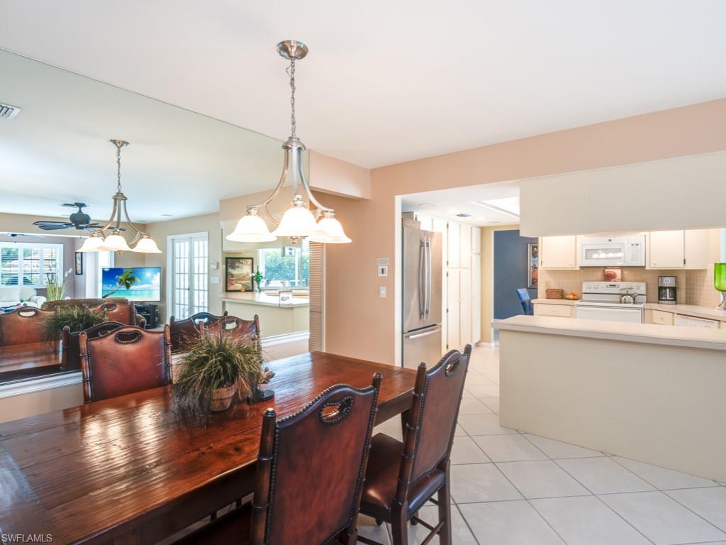 1820 Kingfish Road Naples, FL 34102 - Photo 11 of 20 a dining room with furniture window wooden floor