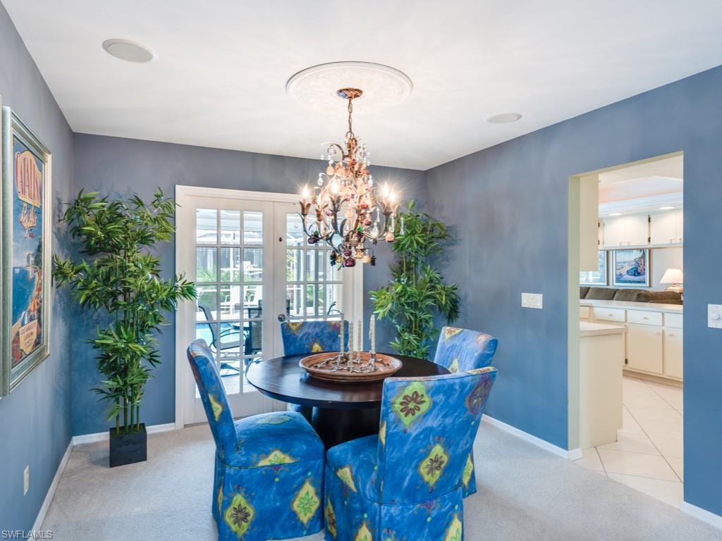 1820 Kingfish Road Naples, FL 34102 - Photo 12 of 20 a view of a dining room with furniture and chandelier