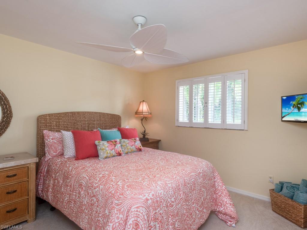 1820 Kingfish Road Naples, FL 34102 - Photo 16 of 20 a bedroom with a bed and a window