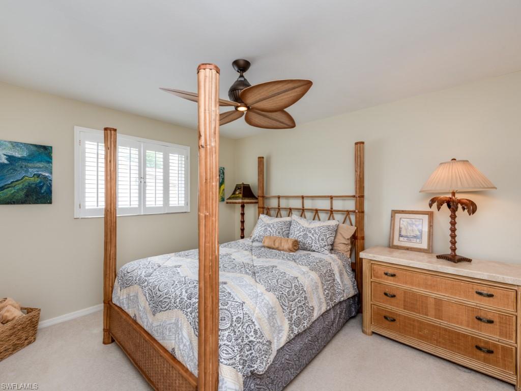 1820 Kingfish Road Naples, FL 34102 - Photo 17 of 20 a bedroom with bed and window