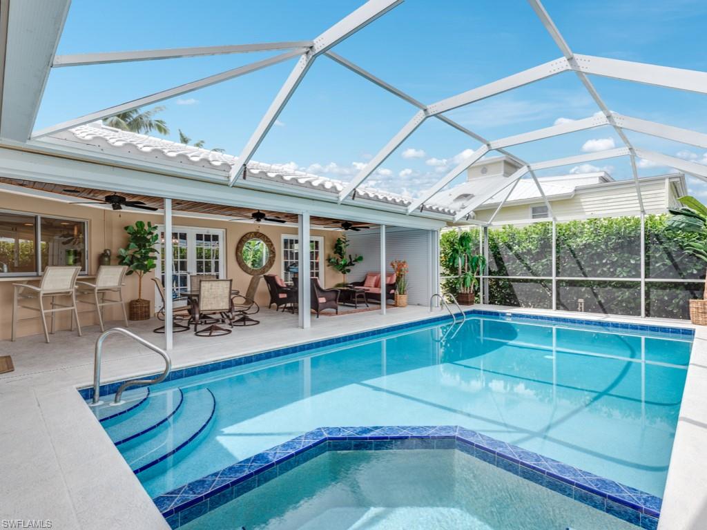1820 Kingfish Road Naples, FL 34102 - Photo 18 of 20 a view of a living room and hall with furniture