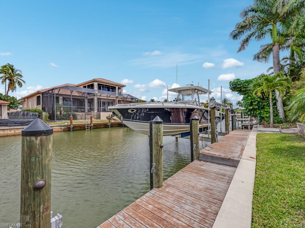 1820 Kingfish Road Naples, FL 34102 - Photo 3 of 20 a front view of a house with a yard