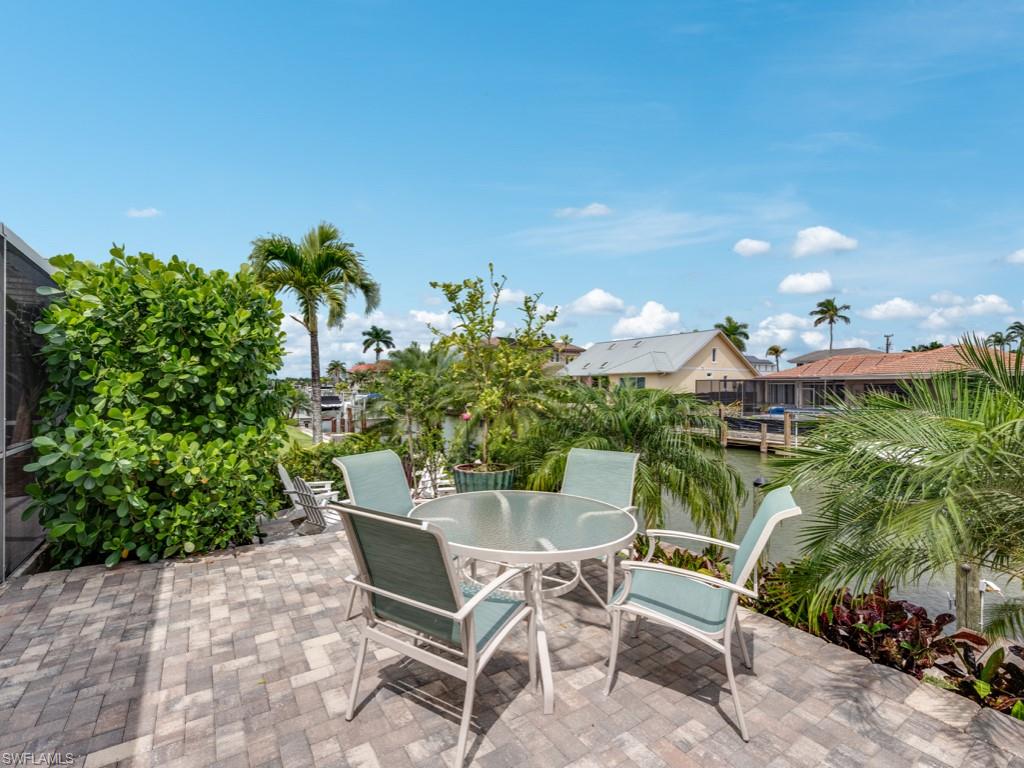 1820 Kingfish Road Naples, FL 34102 - Photo 6 of 20 a view of a chairs and table in the patio