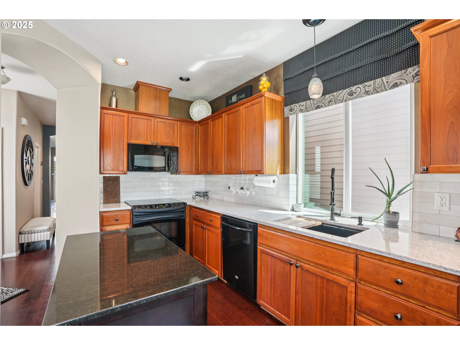 20621 Southwest Rosemount Street Beaverton, OR 97078 - Photo 12 of 37 a kitchen with stainless steel appliances a sink stove and cabinets