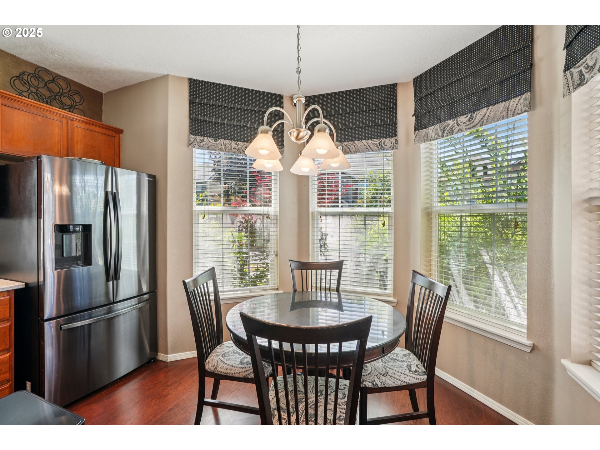 20621 Southwest Rosemount Street Beaverton, OR 97078 - Photo 14 of 37 a kitchen with stainless steel appliances granite countertop a dining table and a refrigerator