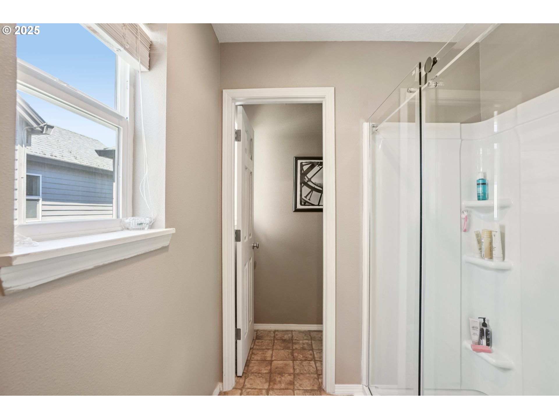 20621 Southwest Rosemount Street Beaverton, OR 97078 - Photo 16 of 37 a view of a bathroom with a shower and a mirror