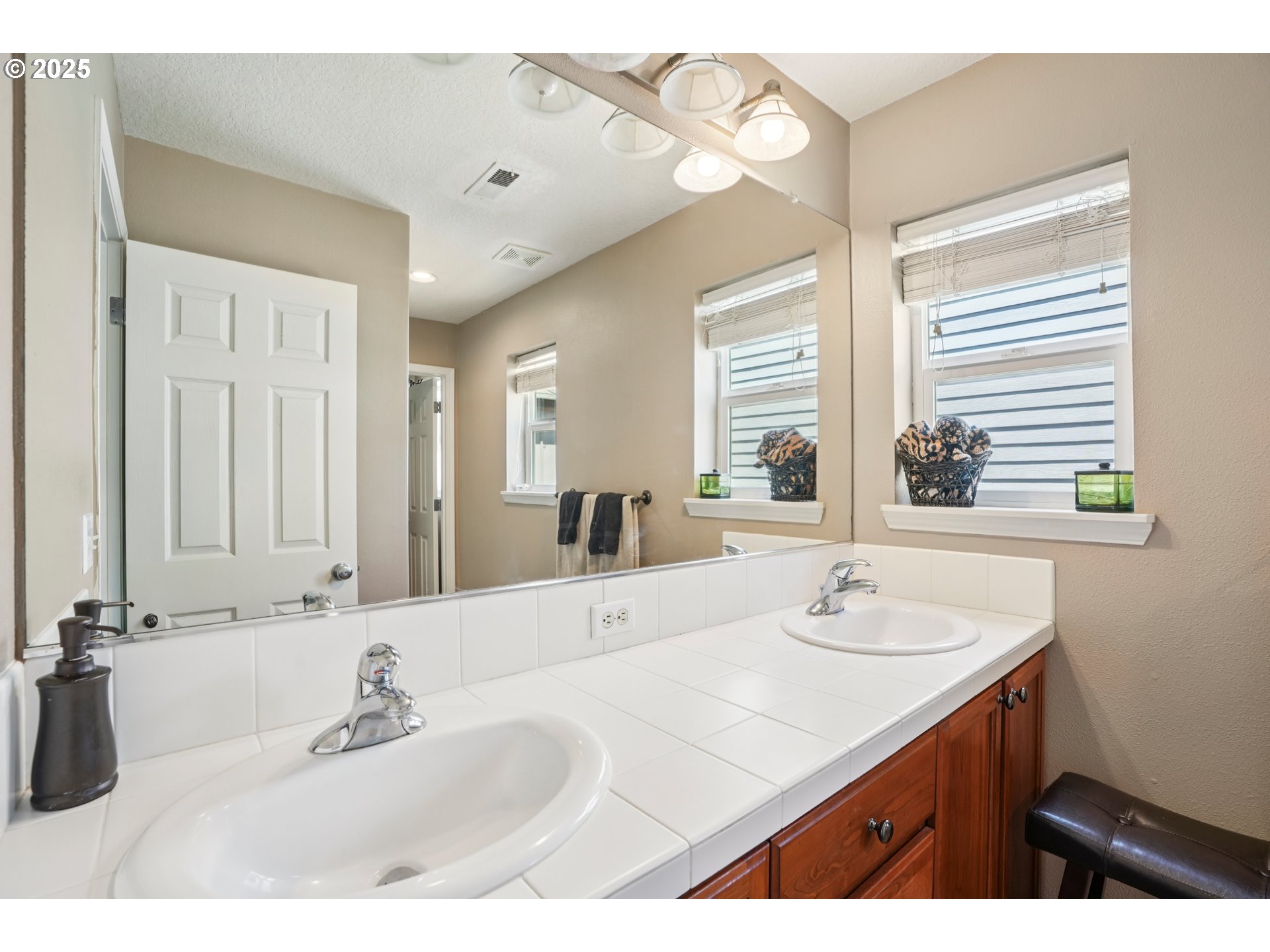 20621 Southwest Rosemount Street Beaverton, OR 97078 - Photo 17 of 37 a bathroom with a sink double vanity and a mirror