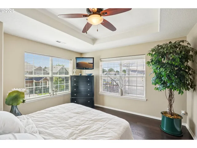 a bedroom with a bed dresser and a window