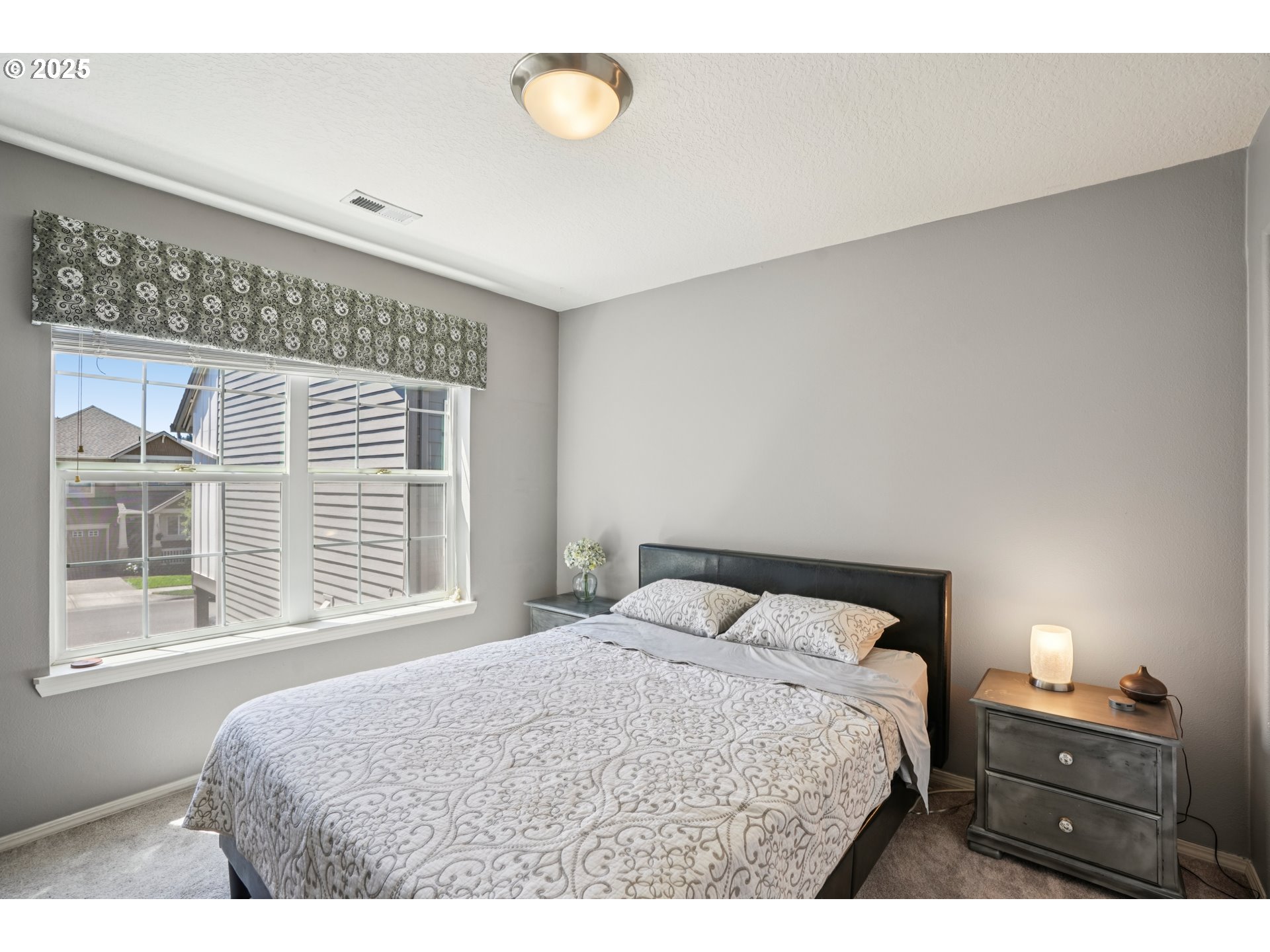 20621 Southwest Rosemount Street Beaverton, OR 97078 - Photo 27 of 37 a bedroom with a bed and a window