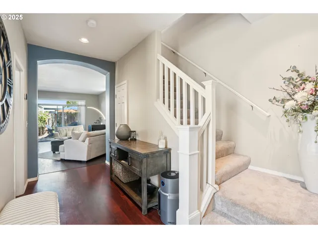a view of entryway livingroom and hall with wooden floor