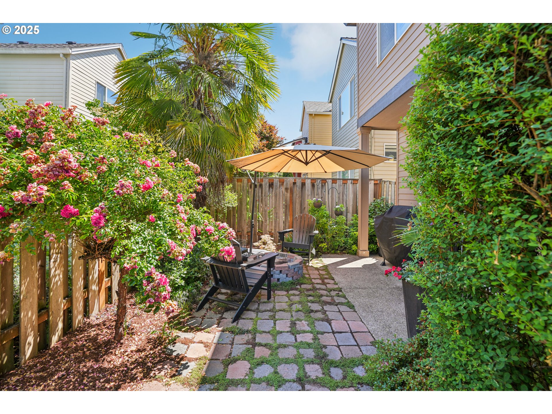 20621 Southwest Rosemount Street Beaverton, OR 97078 - Photo 34 of 37 a view of a chairs and table under an umbrella in backyard