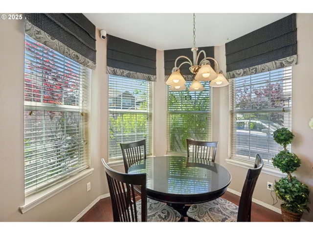 a dining room with furniture window and outside view