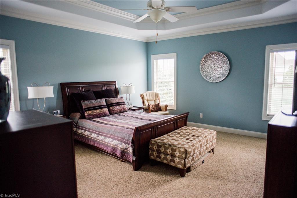 1743 Diercrest Street Oak Ridge, NC 27310 - Photo 15 of 30 Spacious master suite features a pretty tray ceiling & fan.