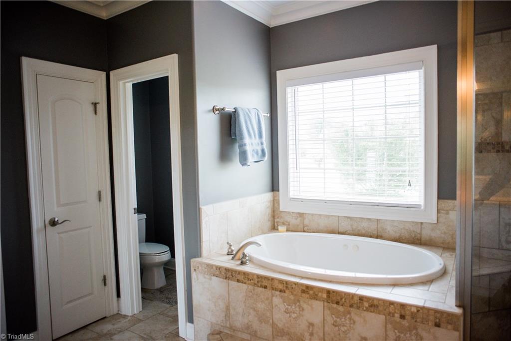 1743 Diercrest Street Oak Ridge, NC 27310 - Photo 16 of 30 Luxurious master bath with soaking tub, separate still shower, double vanities, walk-in closet & separate water closet.