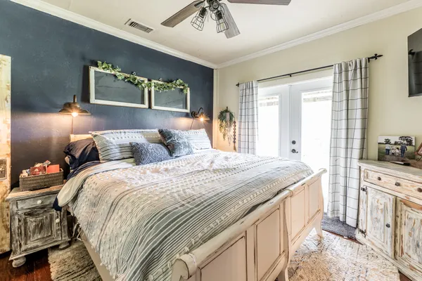 a bed sitting in a spacious bedroom next to a window