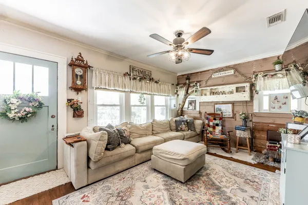 a living room with furniture and a large window