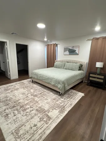 a bedroom with a bed and a couch