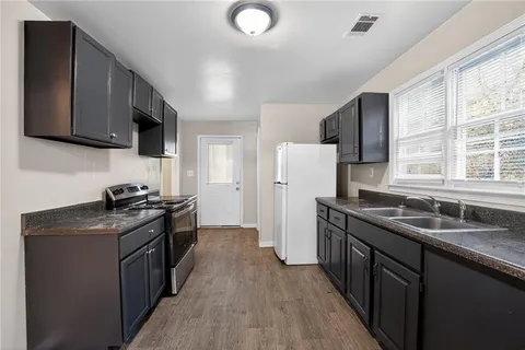 a kitchen with a sink stove and refrigerator