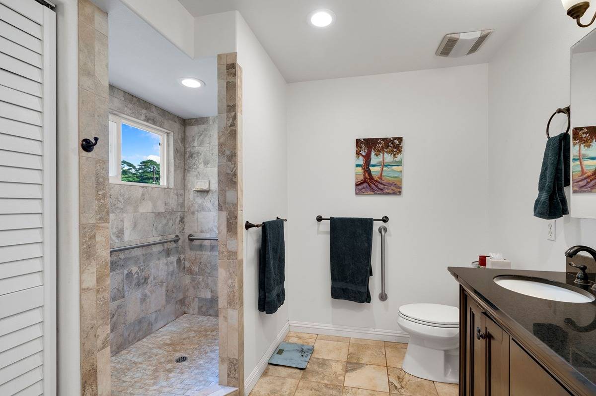 3708 Akea Road Hanapepe, HI 96705 - Photo 11 of 30 a bathroom with a granite countertop toilet a sink and a mirror