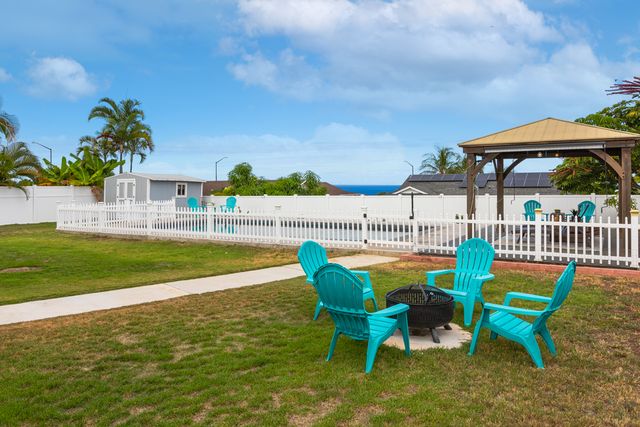 a view of lawn chairs and table in the patio