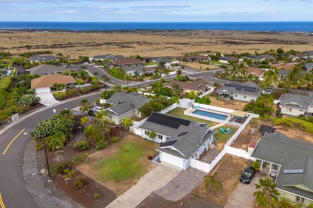 front view of a brick house with a yard
