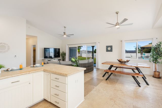 a spacious bedroom with a bed a table and a flat screen tv