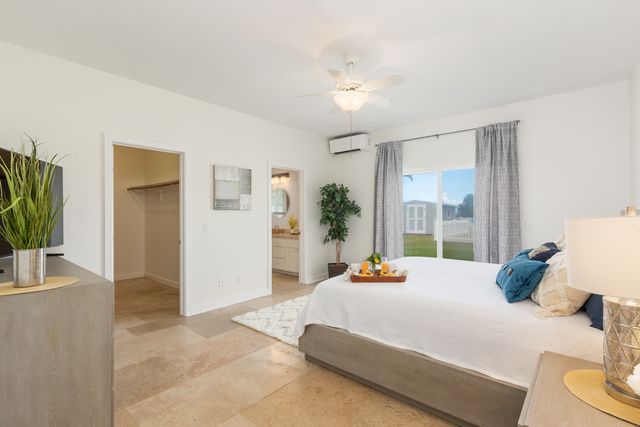 a bedroom with a bed and large window