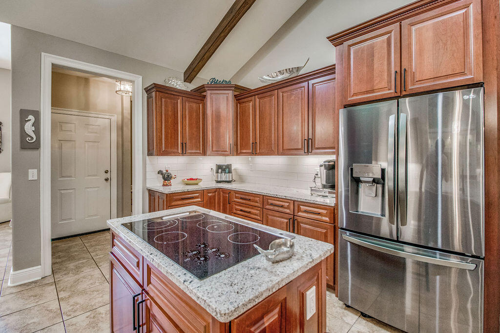 2655 Masters Boulevard Navarre, FL 32566 - Photo 15 of 87 a kitchen with stainless steel appliances granite countertop a refrigerator a sink and a stove