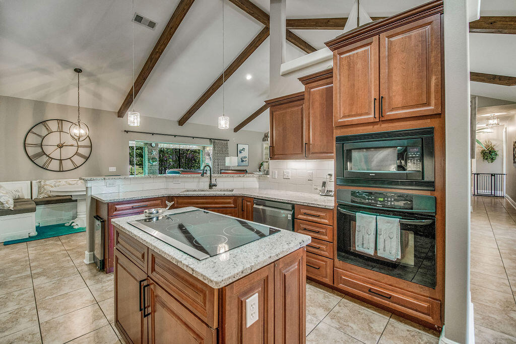 2655 Masters Boulevard Navarre, FL 32566 - Photo 16 of 87 a kitchen with a stove a sink and a refrigerator