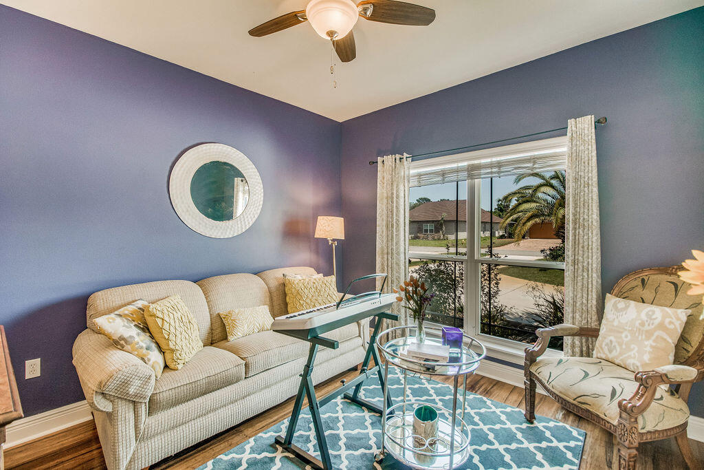 2655 Masters Boulevard Navarre, FL 32566 - Photo 30 of 87 a living room with furniture and a large window