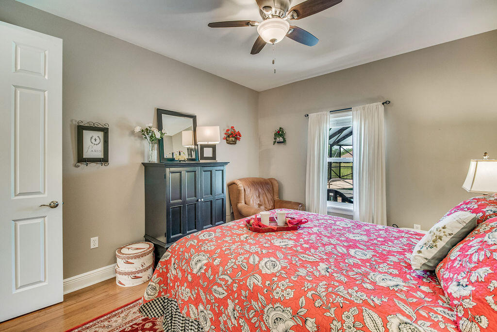 2655 Masters Boulevard Navarre, FL 32566 - Photo 37 of 87 a bedroom with a bed and a chandelier
