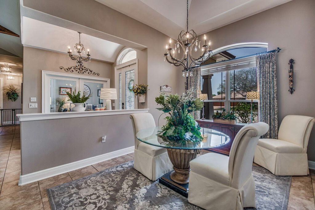 2655 Masters Boulevard Navarre, FL 32566 - Photo 4 of 87 a view of a dining room with furniture a chandelier and window